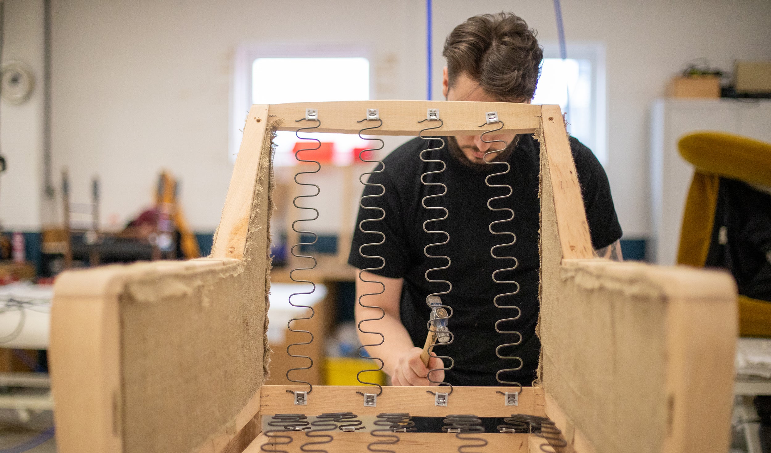 Armchair spings being installed in the Coakley and Cox factory.