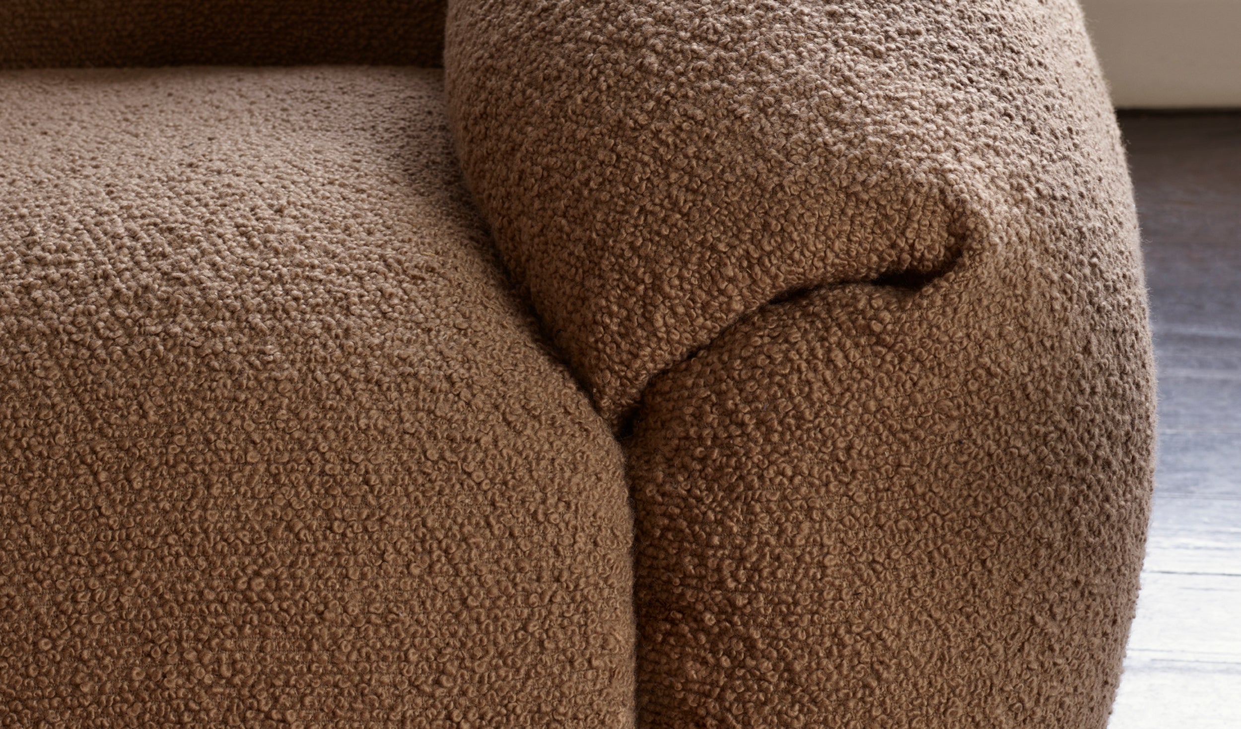 Upholstered armrest of a sofa.